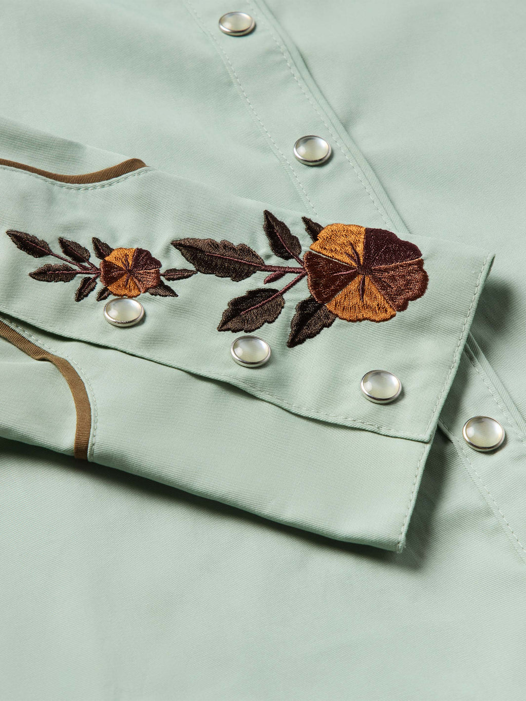 Jade snap-front shirt with dark and tan floral embroidery on chest placket