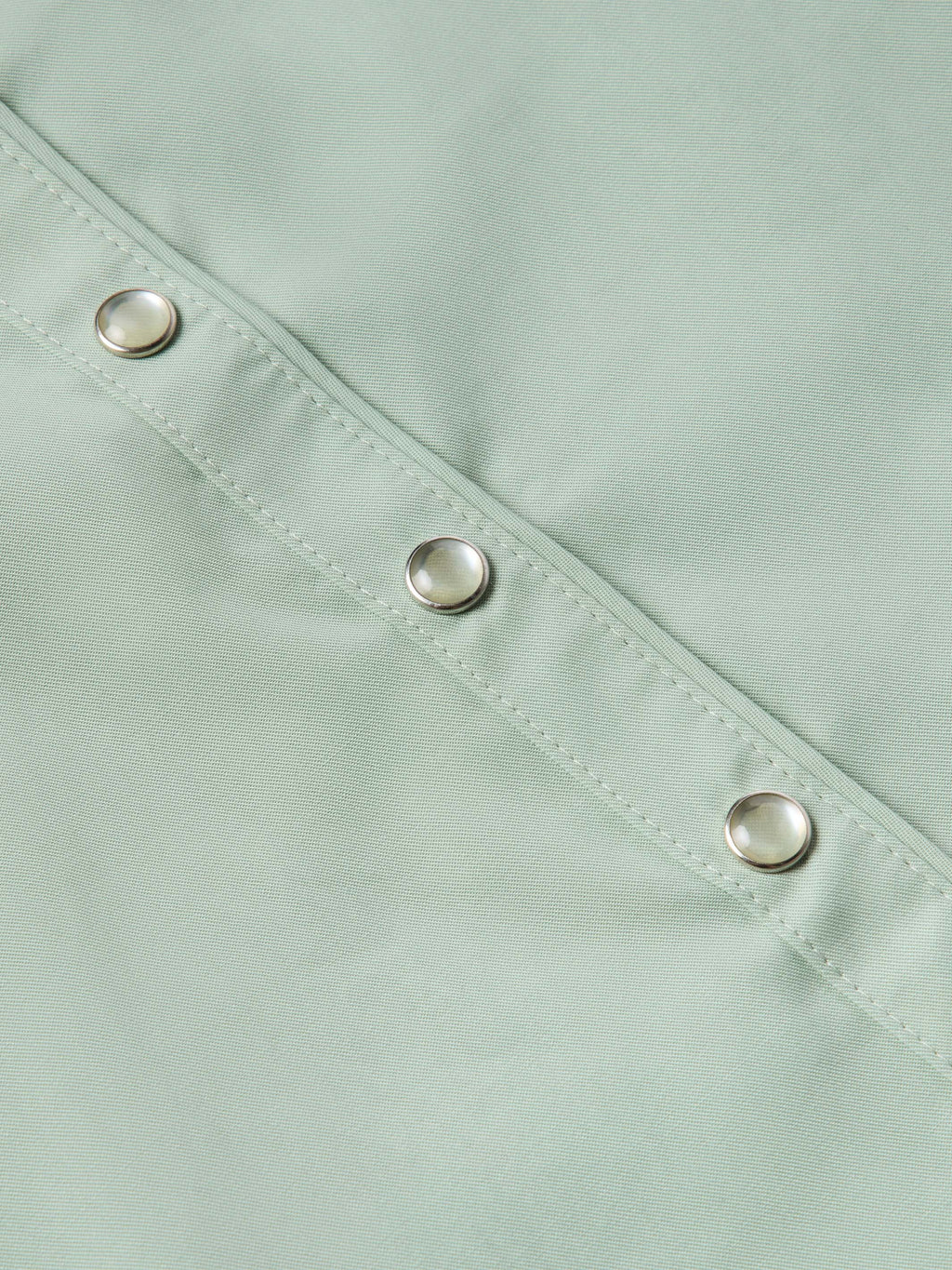 Jade snap-front shirt close-up showing metal snaps along the placket