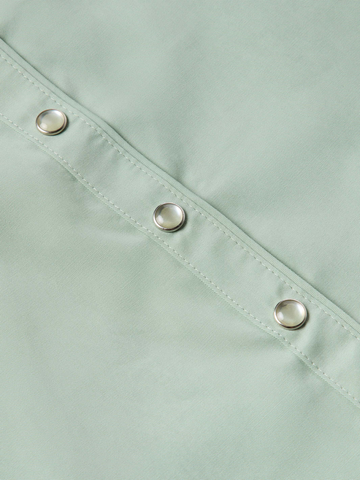 Jade snap-front shirt close-up showing metal snaps along the placket