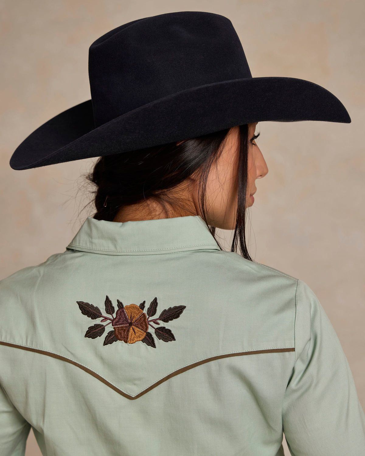 Jade women's embroidered snap shirt back view showing central yoke floral motif
