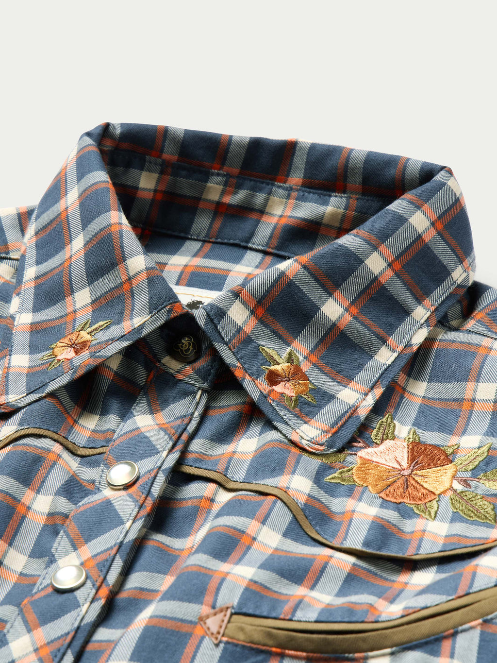 Women’s embroidered snap shirt close-up, plaid collar with floral embroidery
