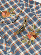 Women’s embroidered snap shirt close-up, plaid chest with embroidered floral and curved yoke