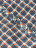Women’s embroidered snap shirt close-up, sleeve cuff with snap buttons and plaid