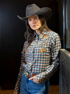 Women’s embroidered snap shirt worn by model, blue plaid with embroidered chest detail