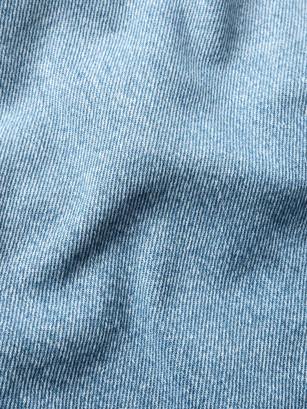 Light wash denim fabric texture close-up