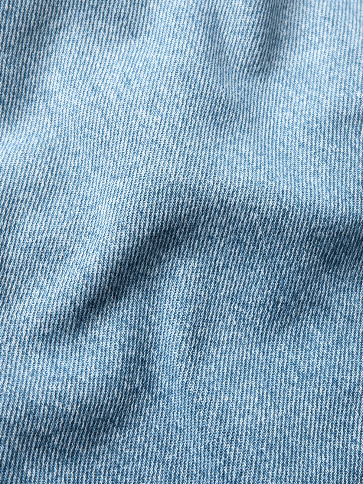 Light wash denim fabric texture close-up