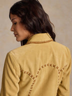 Buttercream suede jacket back with curved whipstitch embroidery and contrast trim