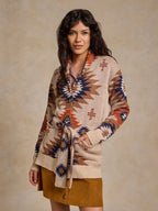 Belted knit sweater with geometric pattern, buttoned collar and long sleeves