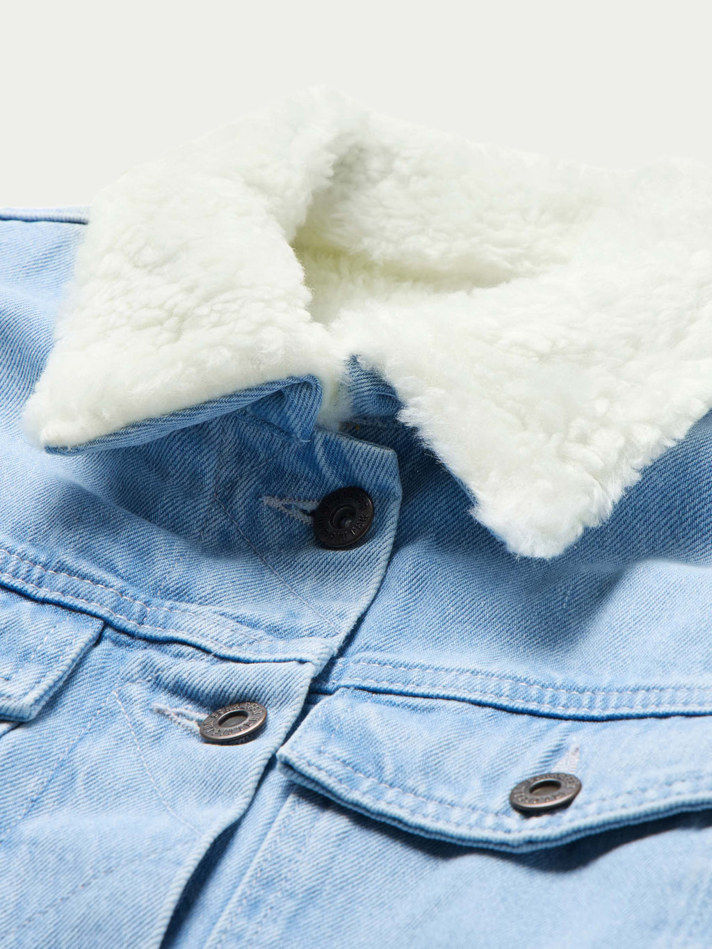 Light blue denim jacket with cream sherpa collar lining and metal button placket