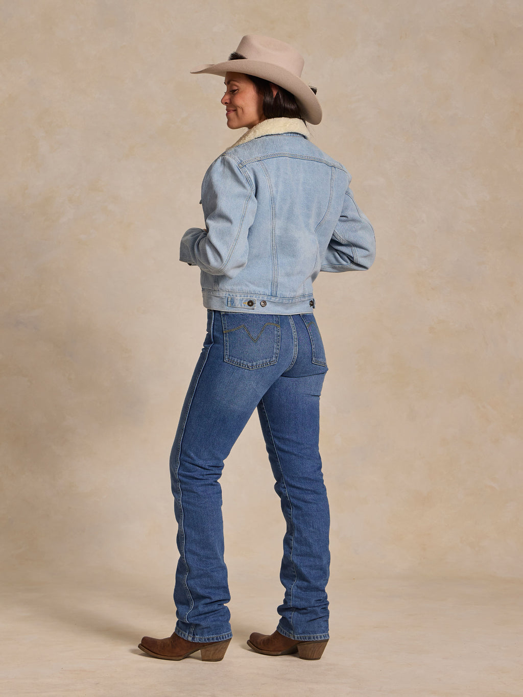 Light wash denim sherpa-lined jacket, button front, back view, cuff and seams
