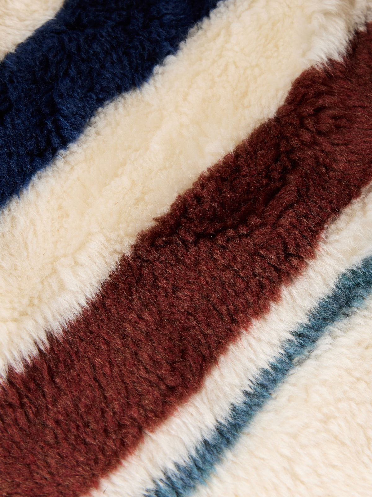 Striped fleece fabric swatch with navy, cream, and rust-brown tones