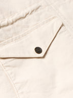 Off-white coat sleeve cuff detail with snap button and stitched seam