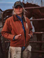 Women’s rust-orange ranch jacket worn over a blue shirt, featuring snap front and corduroy collar