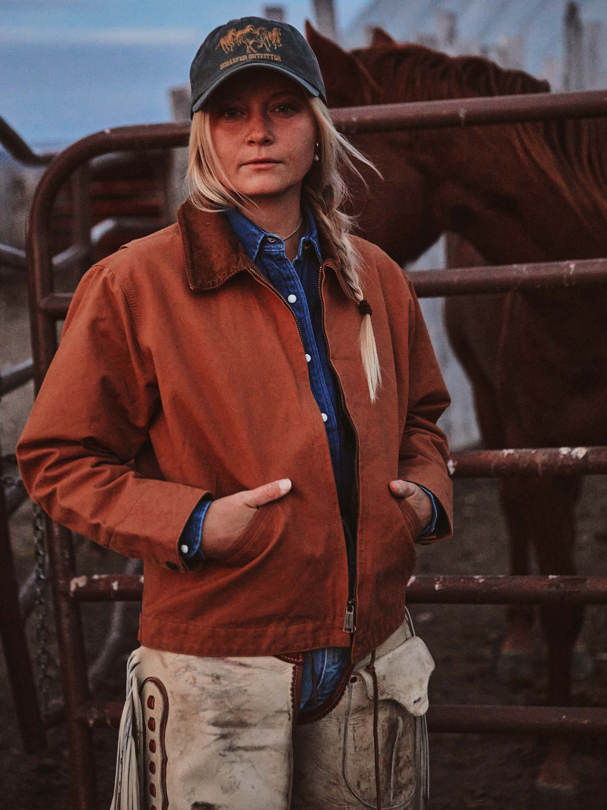 Women’s rust-orange ranch jacket worn over a blue shirt, featuring snap front and corduroy collar