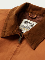 Close-up of rust-orange jacket interior label at corduroy-lined collar