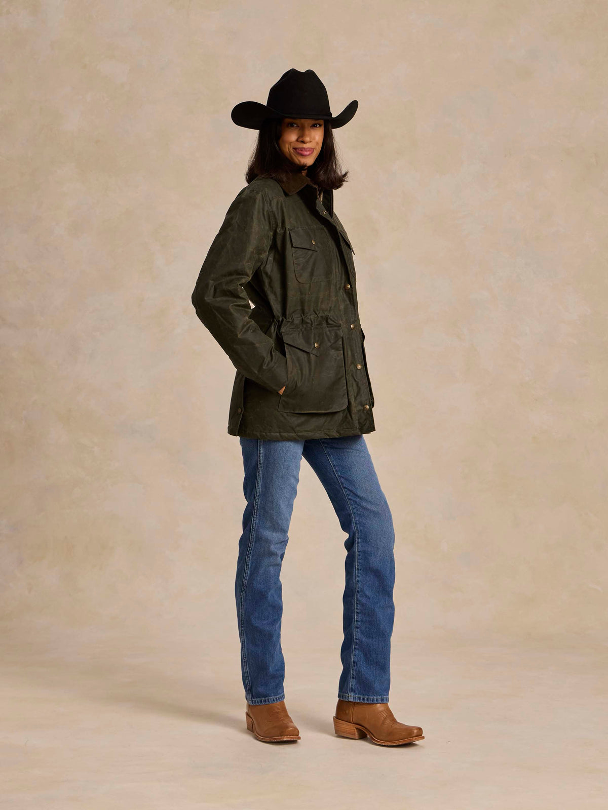 Loden dark green barn coat with button cuffs and chest pockets, three-quarter view