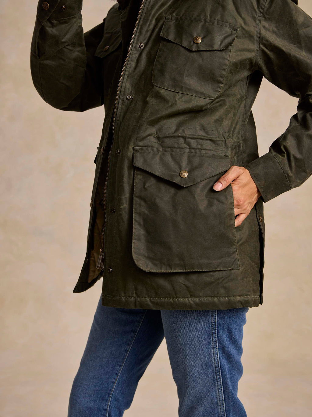 Loden green barn coat with flap pockets and metal snap closure, long sleeves