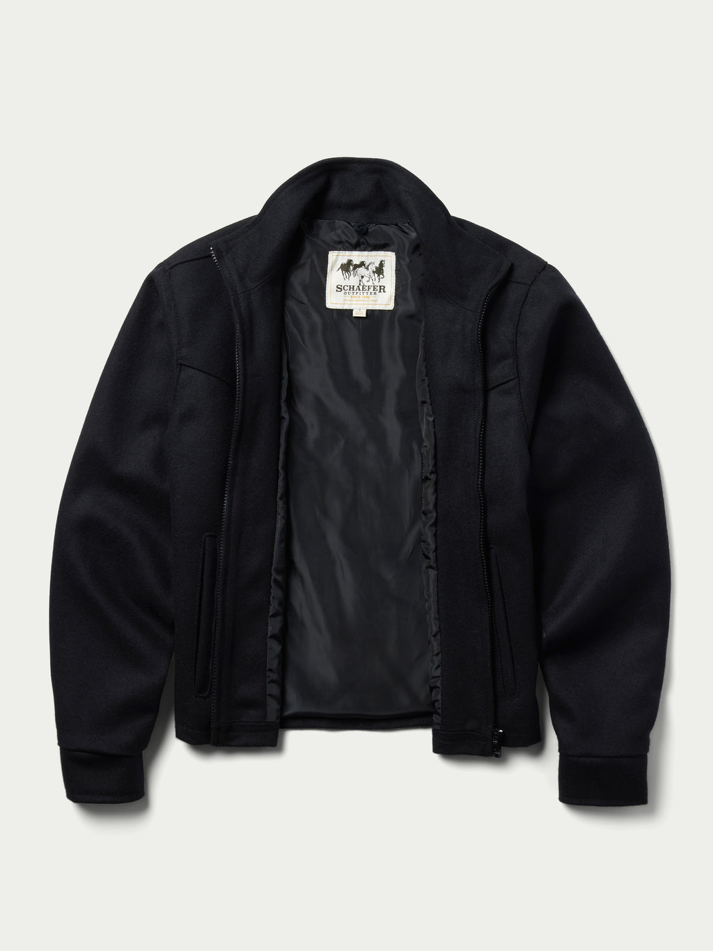 Women's black wool arena jacket with inner plaid lining visible at the zipper