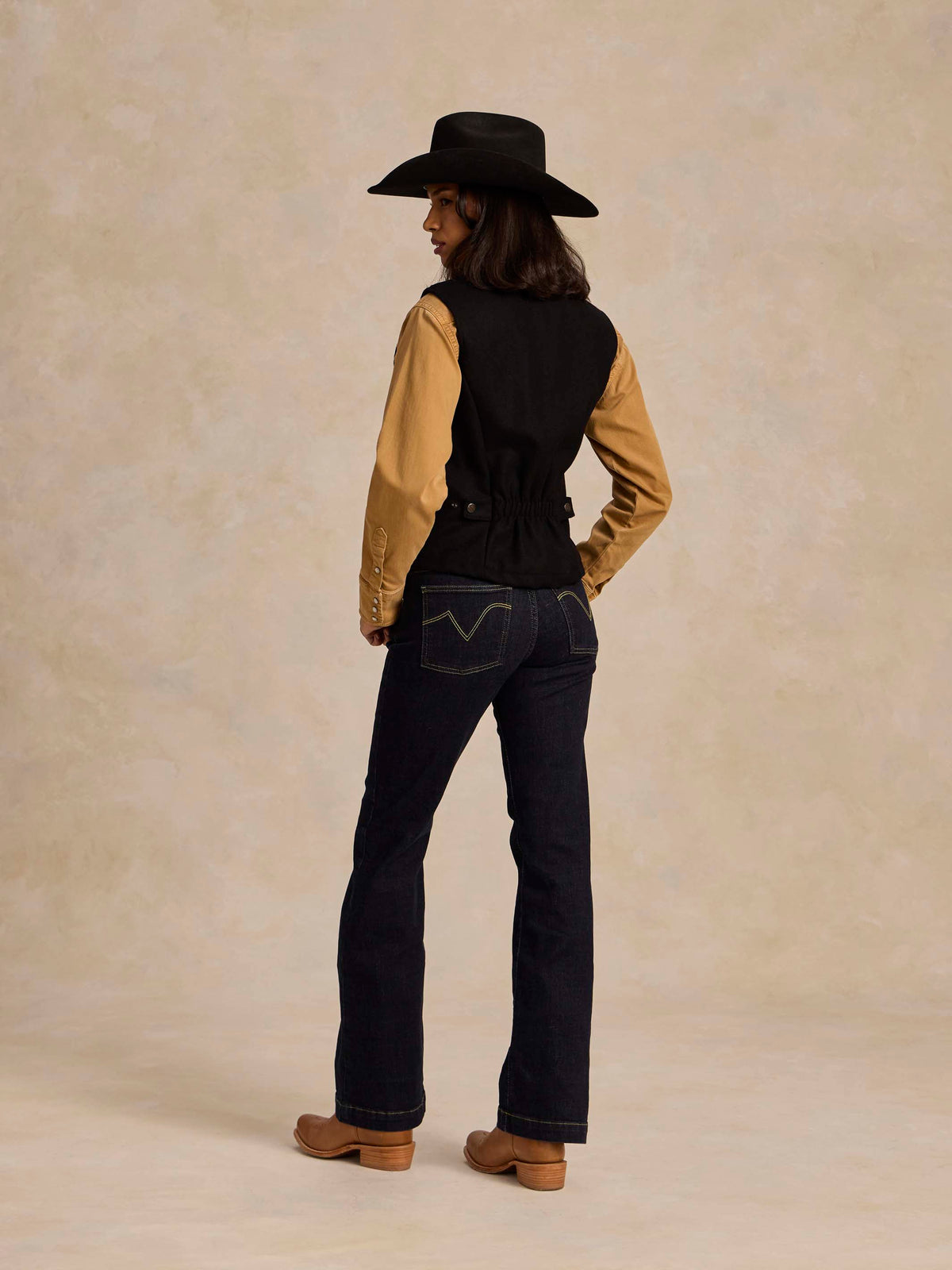 Black wool vest back view with full-zip design and structured yoke