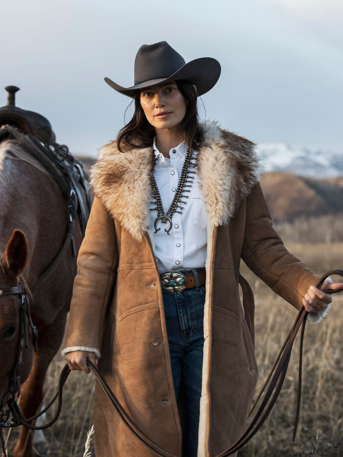 Long chestnut shearling coat with plush fur collar and button-front opening