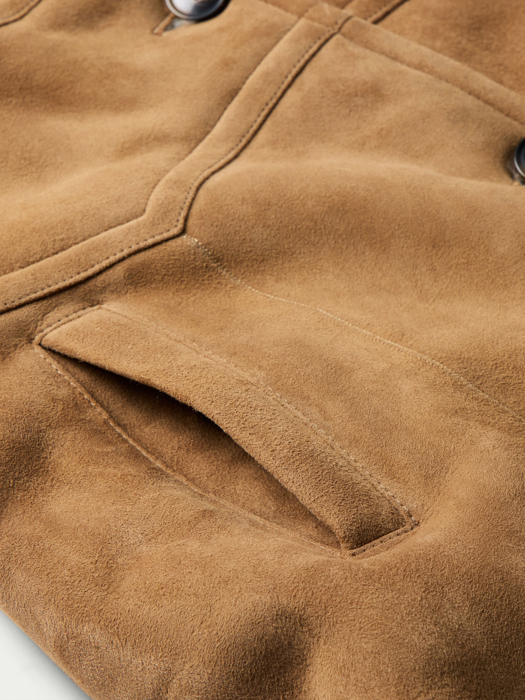 Chestnut shearling coat pocket and seam detail with buttoned flap