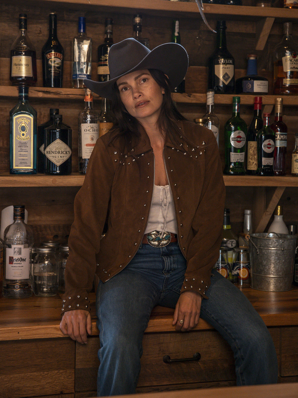 Pecan suede studded jacket on model, full front view with silver studs and zipper
