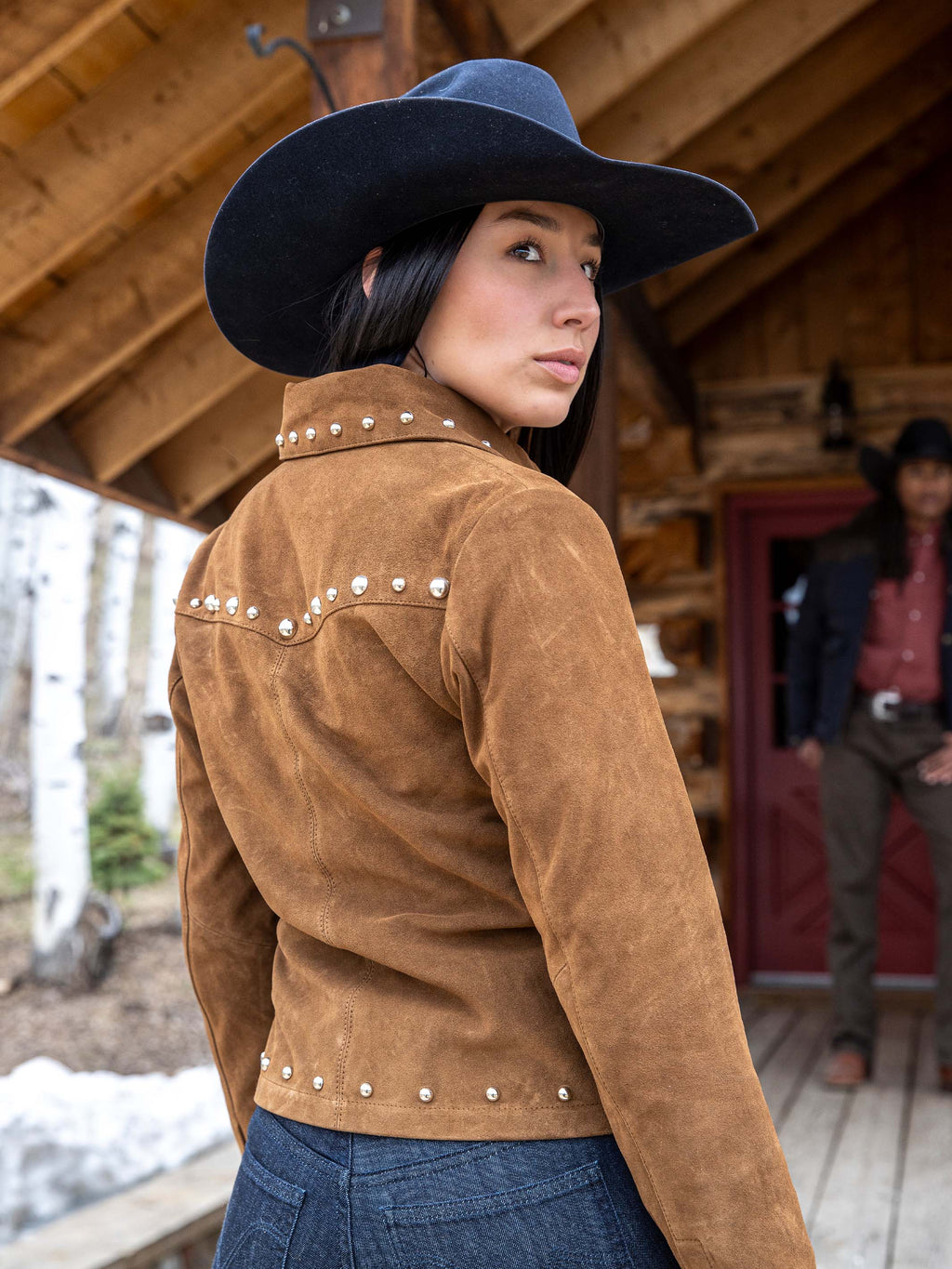 Pecan suede studded jacket on model, side view with silver studs along collar