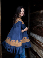 Women's suede fringe cape in navy with tan yoke, scalloped hem, and long fringe