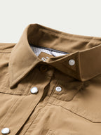 Tan western snap shirt collar with inner branded label and metal snap placket