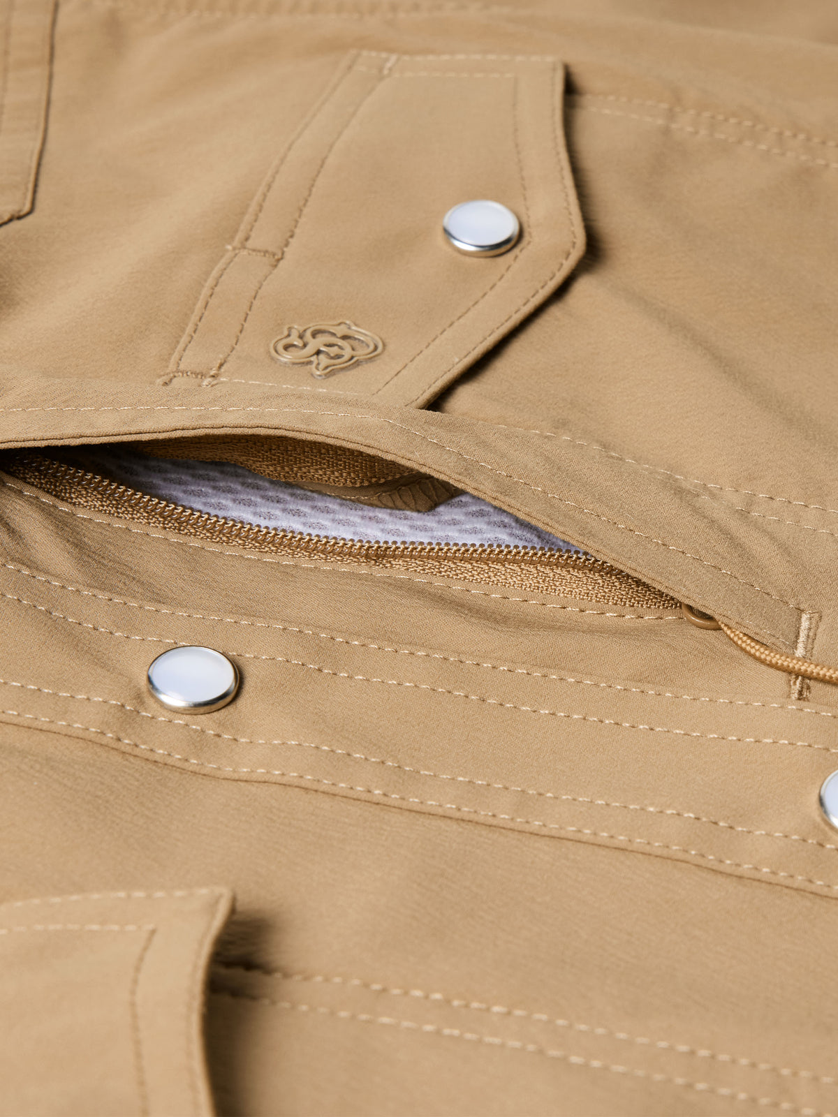 Tan western snap shirt placket with metal snaps and open pocket detail