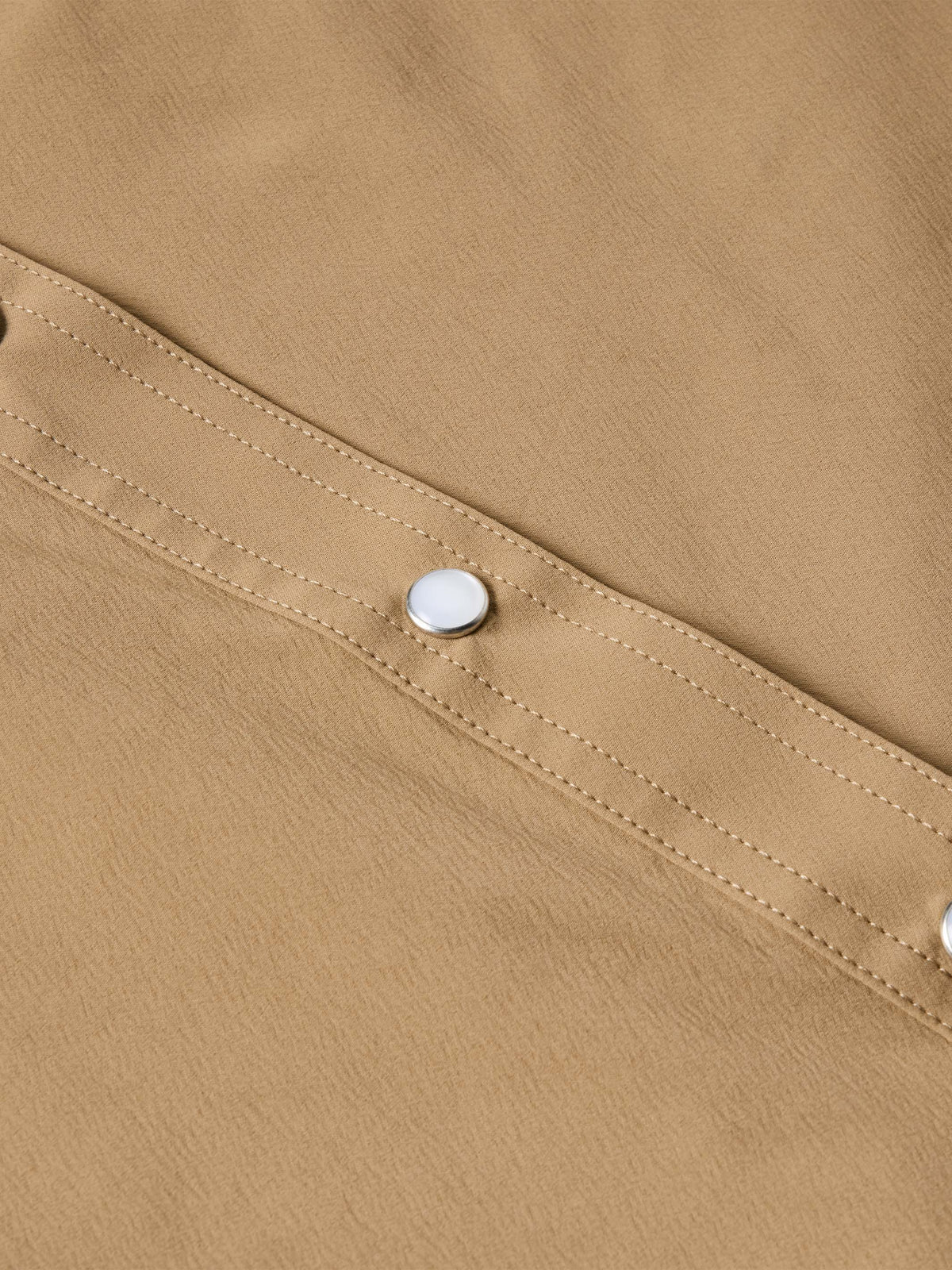 Tan western snap shirt shoulder seam with stitched panel and single snap button