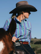 Women’s striped western snap shirt with pointed yoke and chest snap pockets, side view