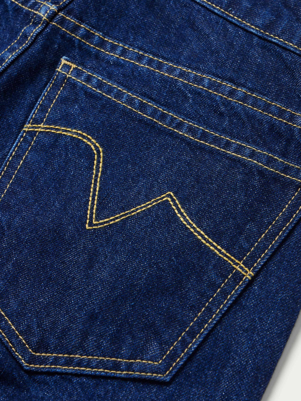 Dark indigo denim pocket detail with contrast topstitching