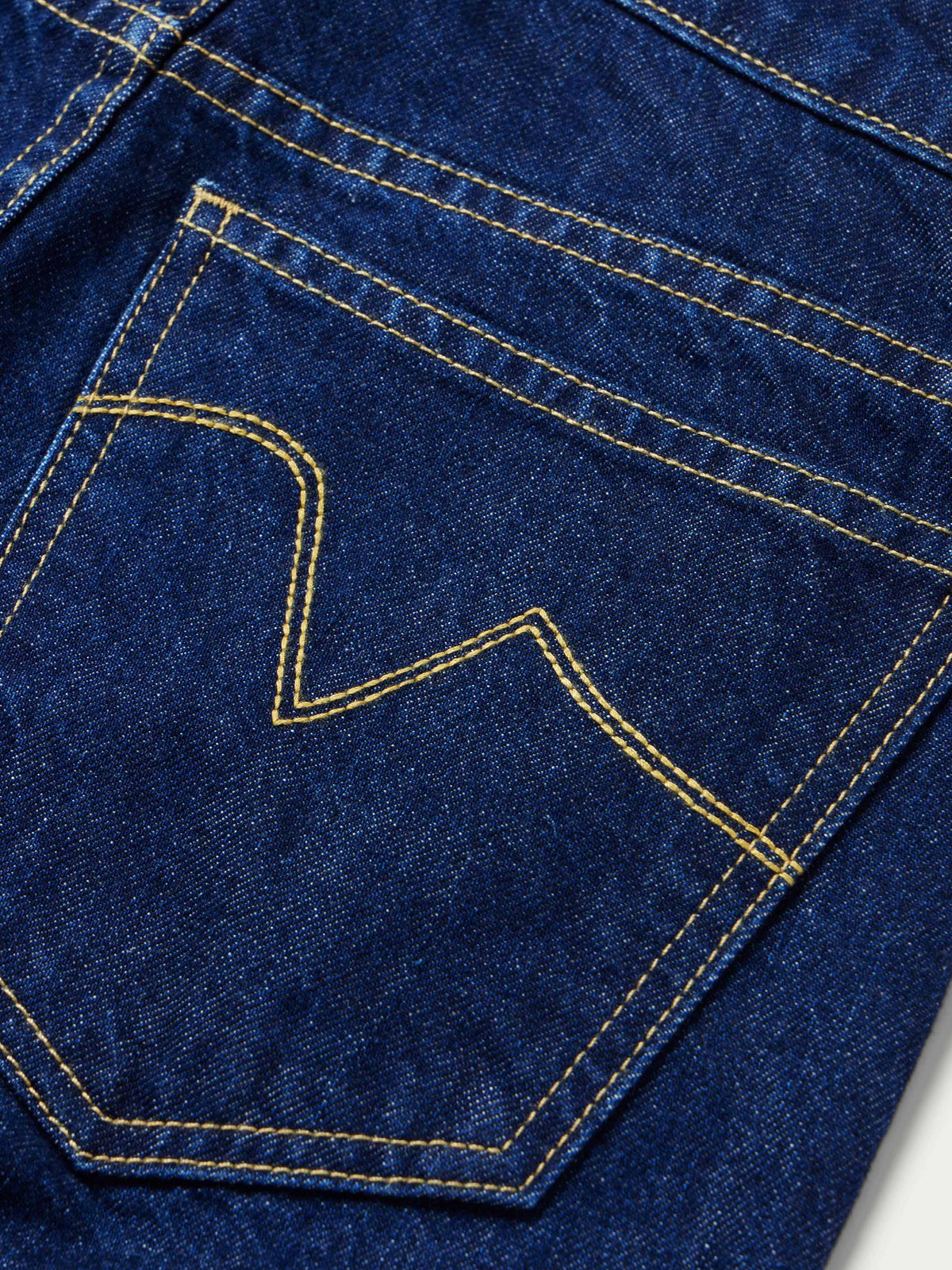 Dark indigo denim pocket detail with contrast topstitching