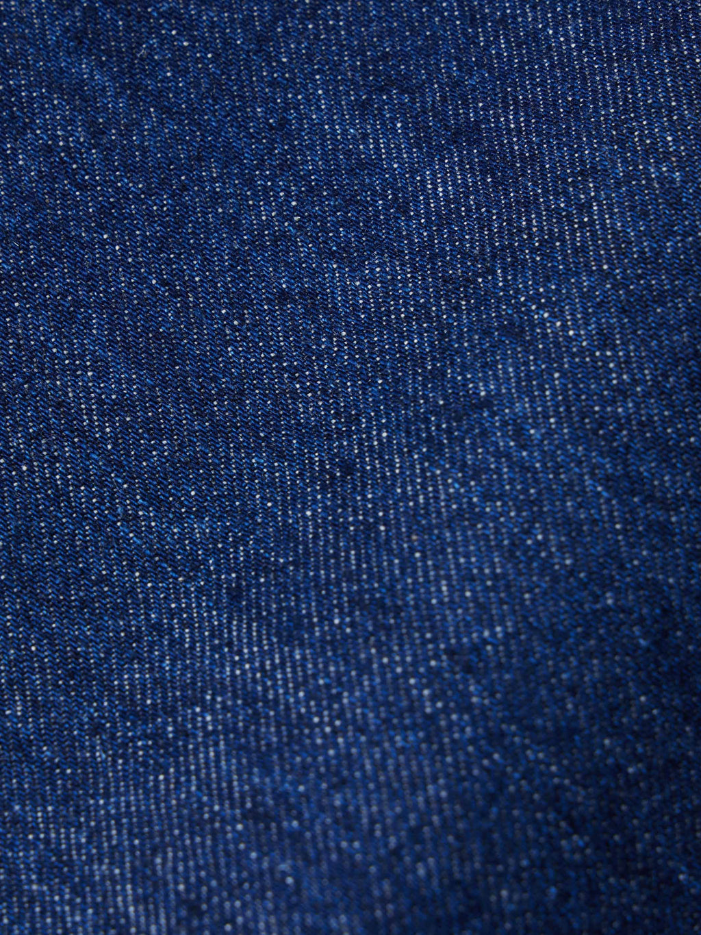 Dark indigo denim fabric texture close-up