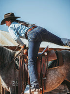 Dark indigo denim jeans with belt loops and five-pocket styling