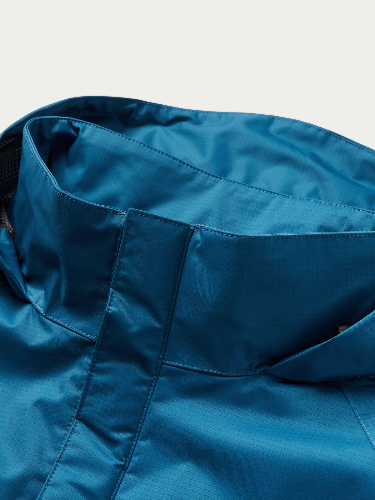 Baltic blue rain jacket hood interior and collar seam detail