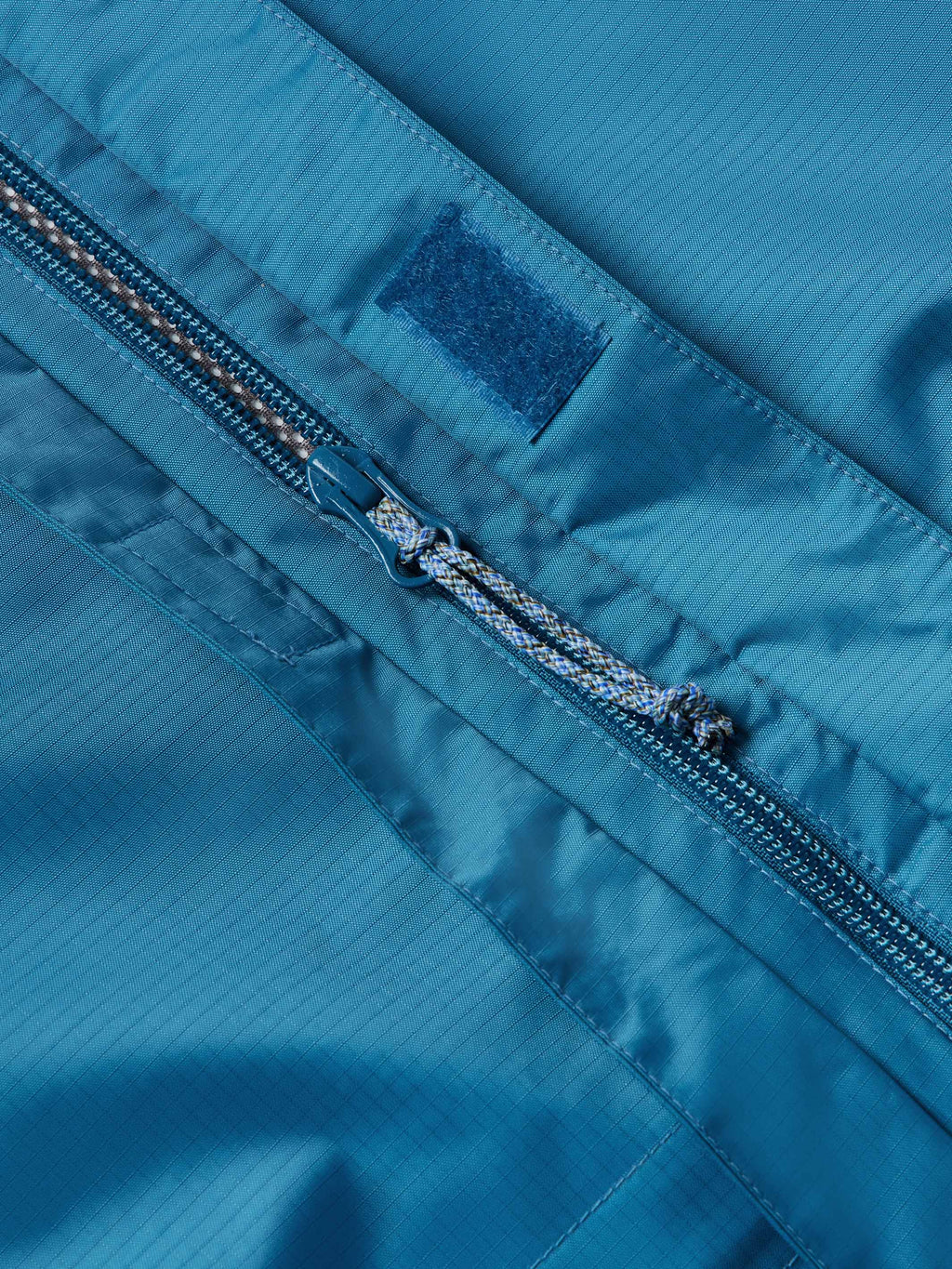 Baltic blue rain jacket front zipper with taped seam and storm flap