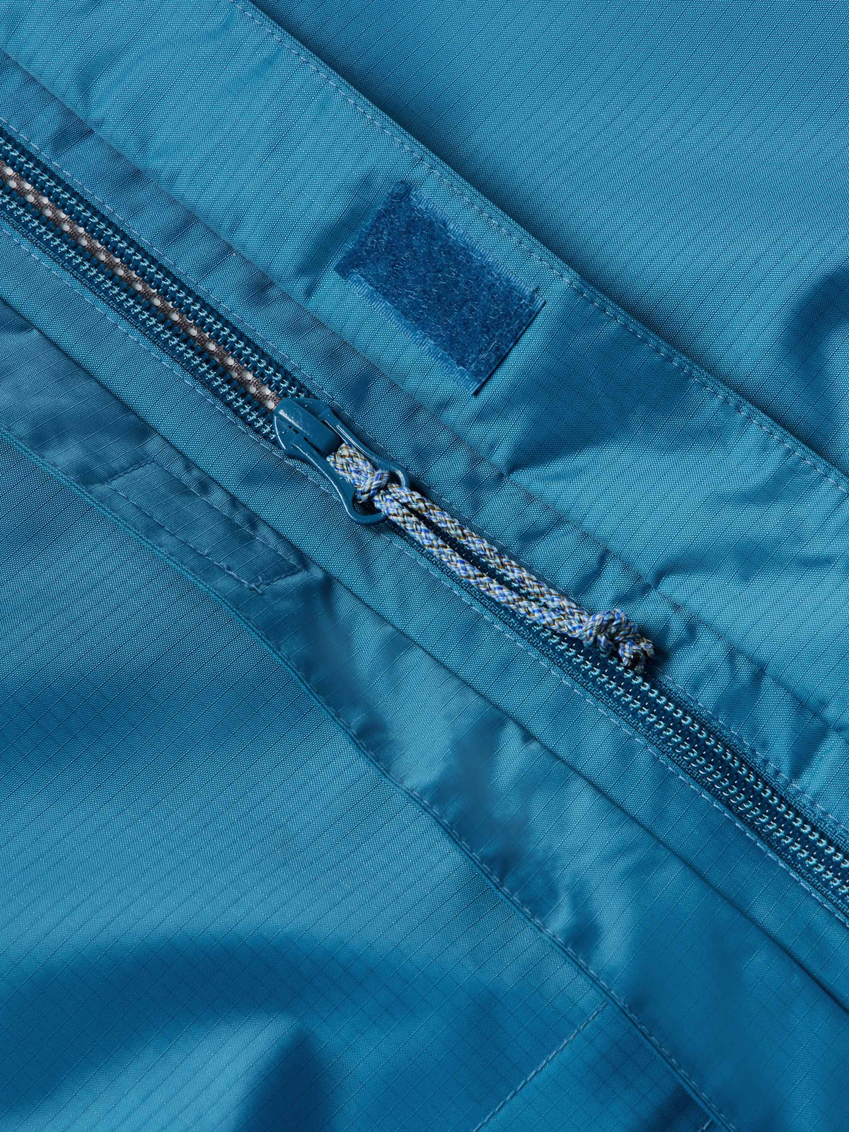 Baltic blue rain jacket front zipper with taped seam and storm flap