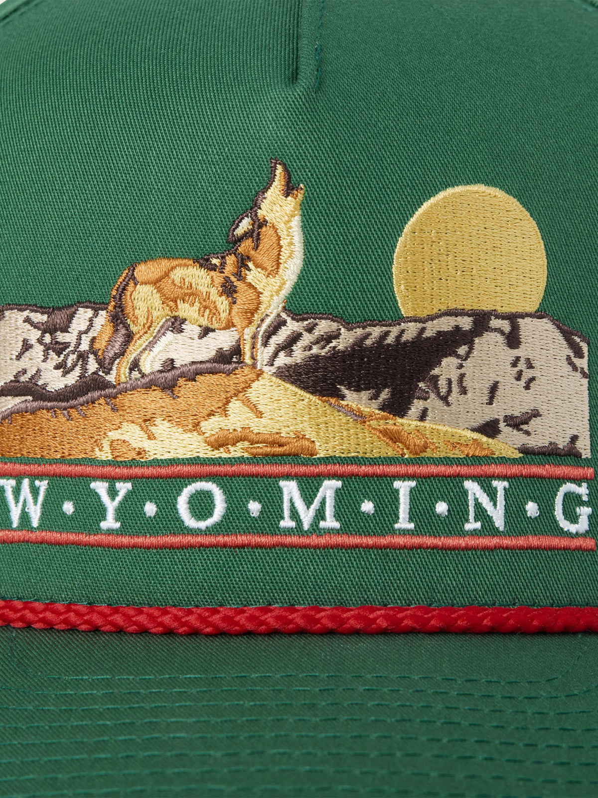 Green cap patch detail with mounted horses and W.Y.O.M.I.N.G text