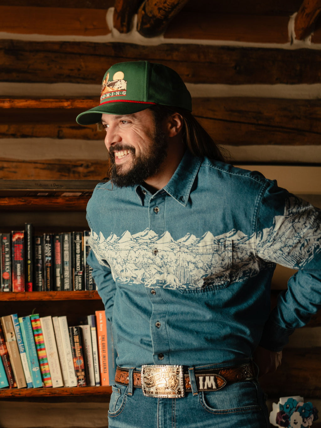 Man wearing green snapback cap with Wyoming graphic patch