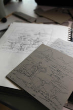 Black-and-white Western map and animal design sketches on paper.
