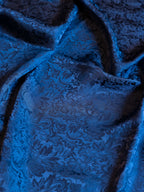 Blue jacquard wild rag fabric with swirling damask pattern