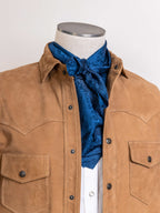 Blue jacquard wild rag scarf with ornate pattern, tied at the neck