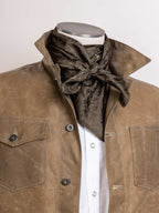 Olive jacquard wild rag with tied bow at front, worn around neck