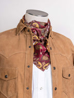 Paisley wild rag scarf in rust, red, and gold paisley print, worn at the neck
