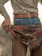 Cocoa paisley wild rag bandana with red and cream swirls, worn around waist