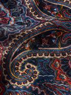 Paisley wild rag fabric close-up in navy with rust and yellow paisley details