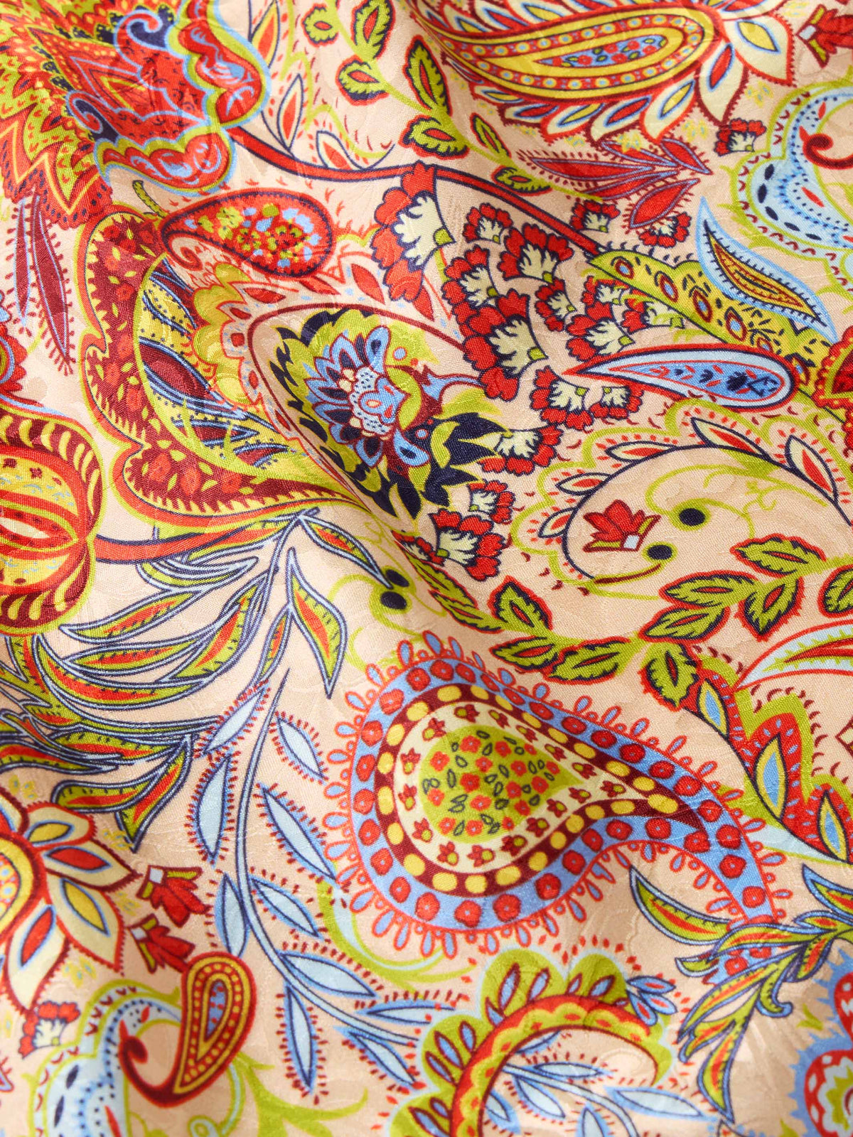Paisley wild rag fabric close-up with detailed red, yellow, blue, and green motifs
