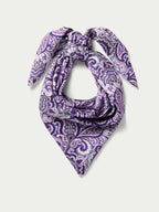 Purple paisley wild rag scarf draped and knotted into a triangle shape